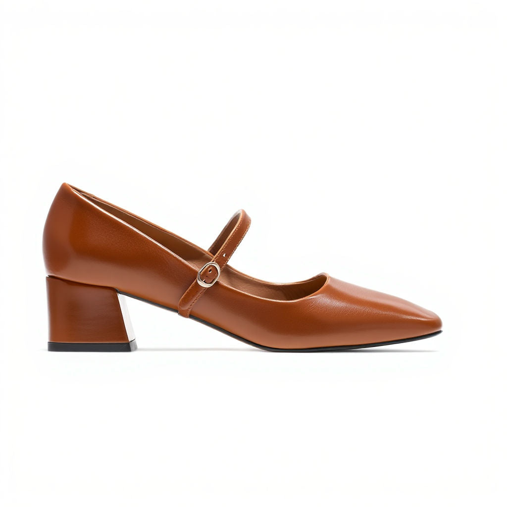 Brown leather shoe with a strap on a white background