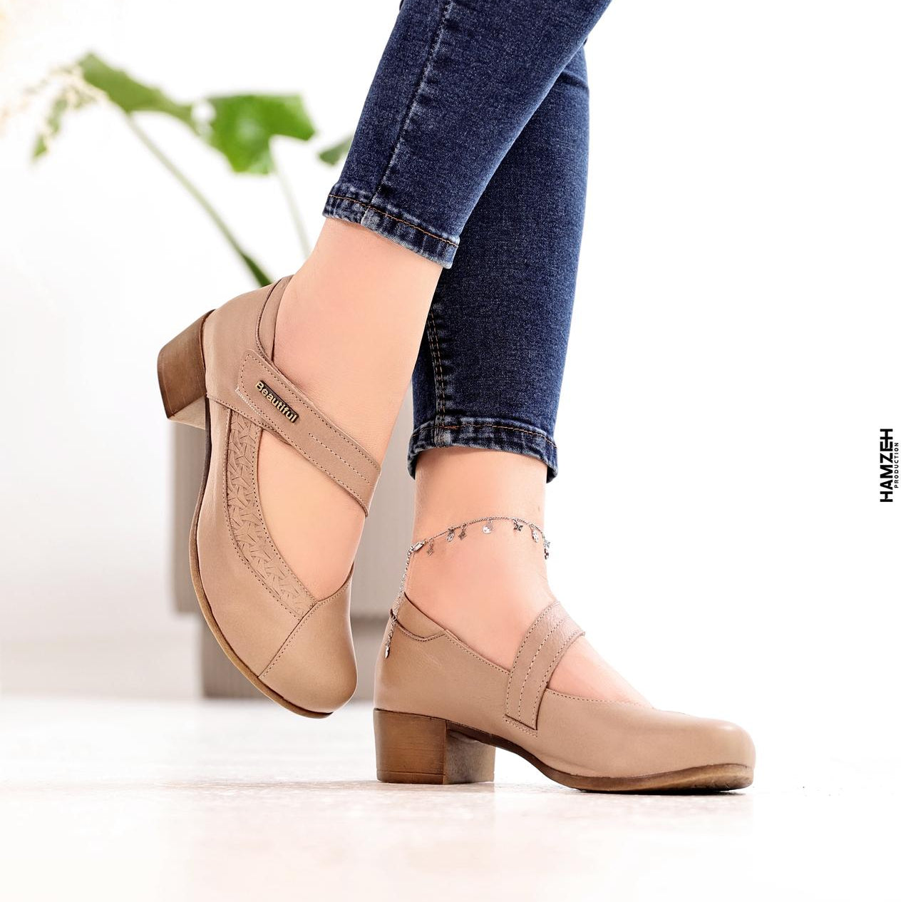 Beige shoes worn with blue jeans on a light background, featuring the 'B Beautiful Comfort' brand.