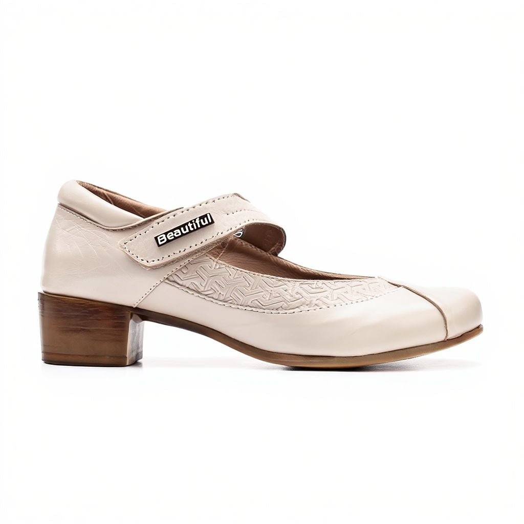 White shoe with brown heel and strap on a white background