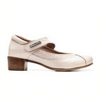 White shoe with brown heel and strap on a white background