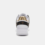 Sneaker with gold and black design on a white background