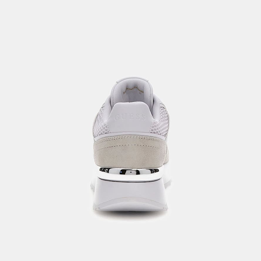 White sneaker with a beige sole on a white background