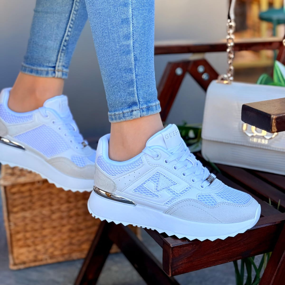 Light blue sneakers worn with light blue jeans on a blurred background