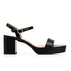 Black sandal with a block heel on a white background