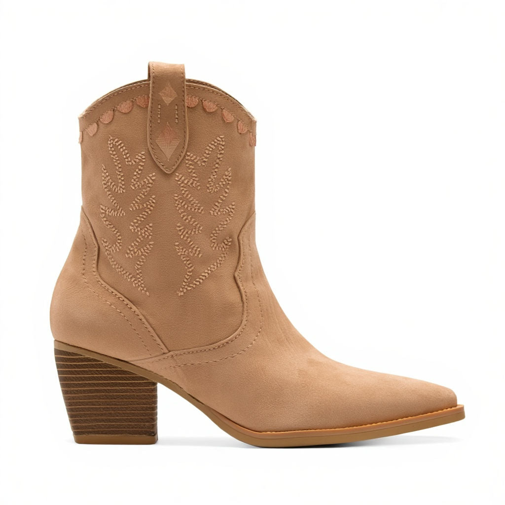 Tan cowboy boot with detailed stitching on a white background