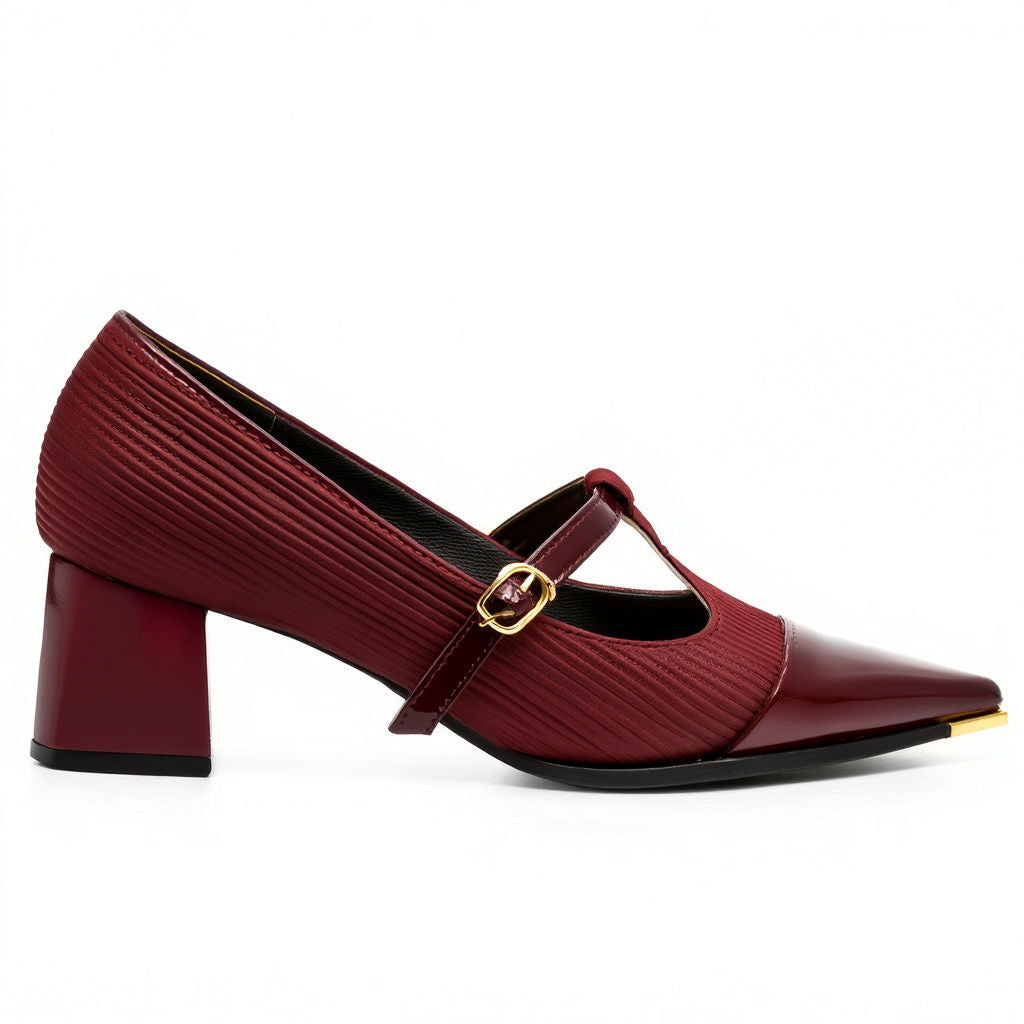 Maroon shoe with a gold strap on a white background