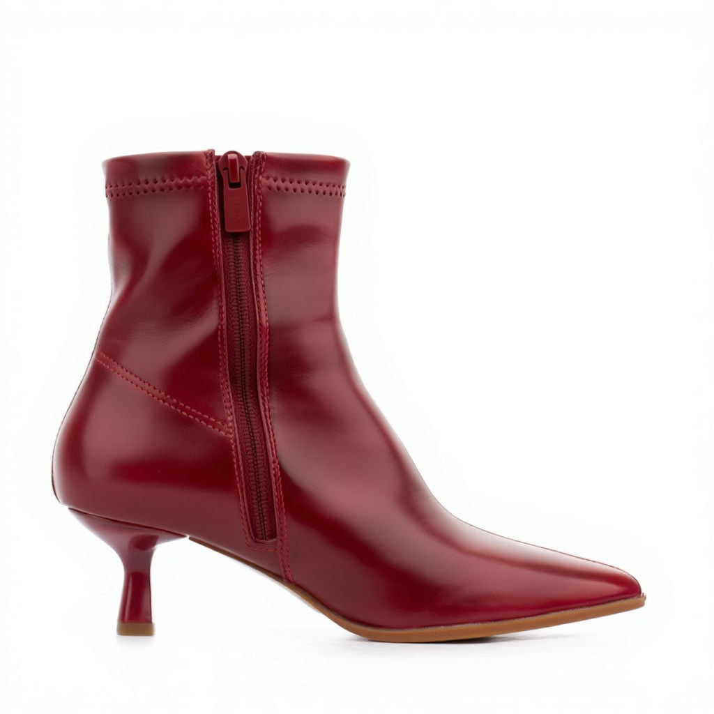 Red ankle boot with a zipper on a white background