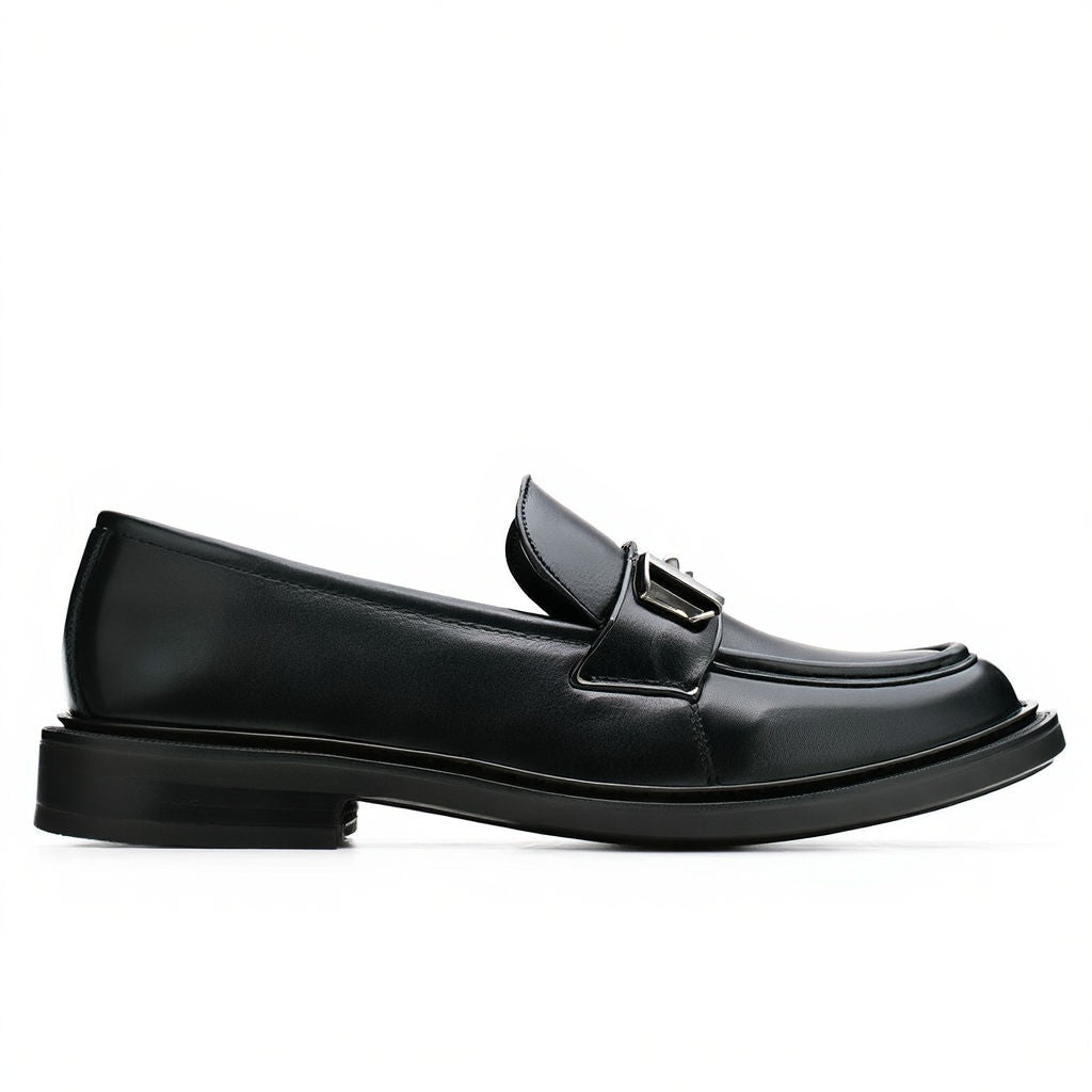 Black loafers on a white background