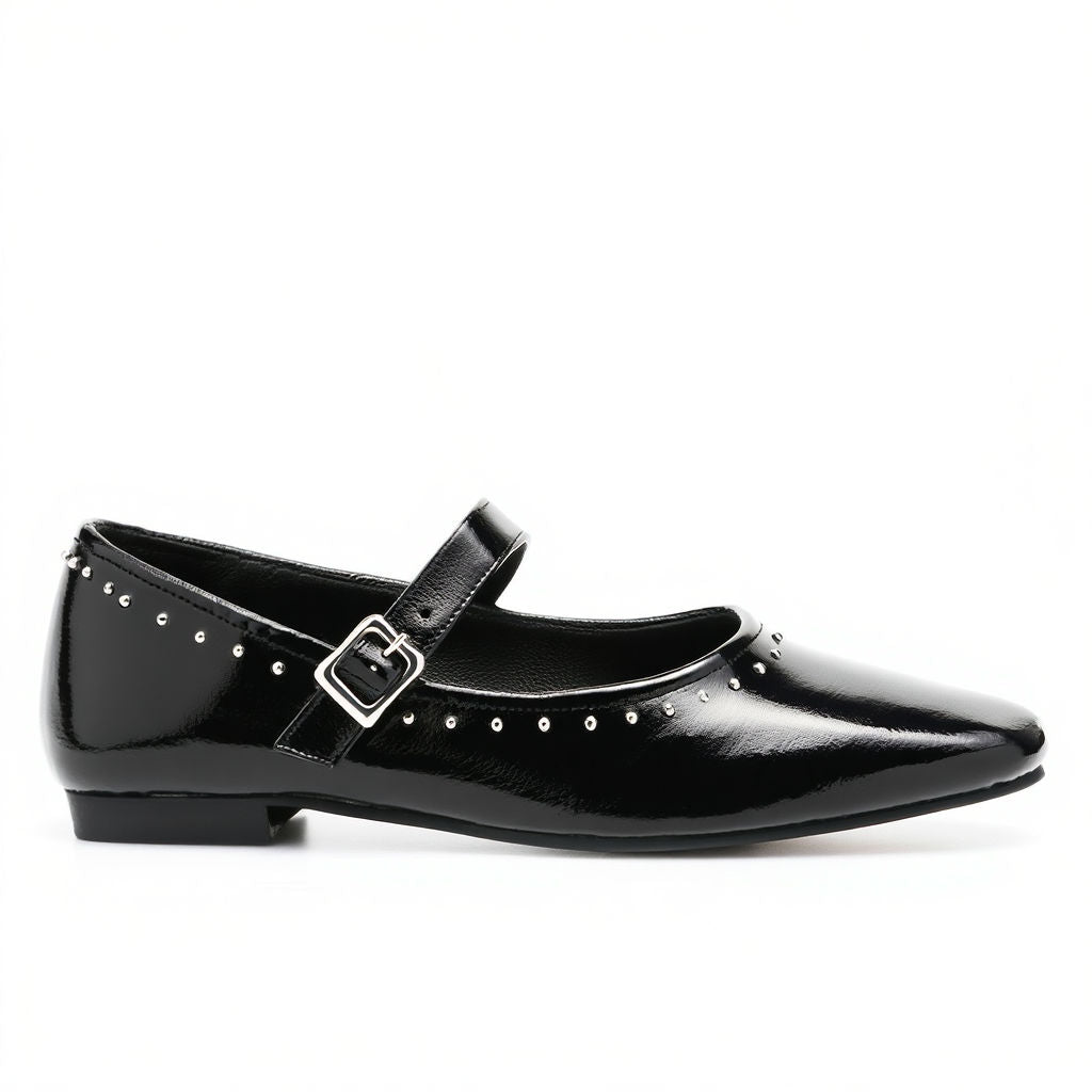Black patent leather shoe with a buckle on a white background