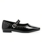 Black patent leather shoe with a buckle on a white background