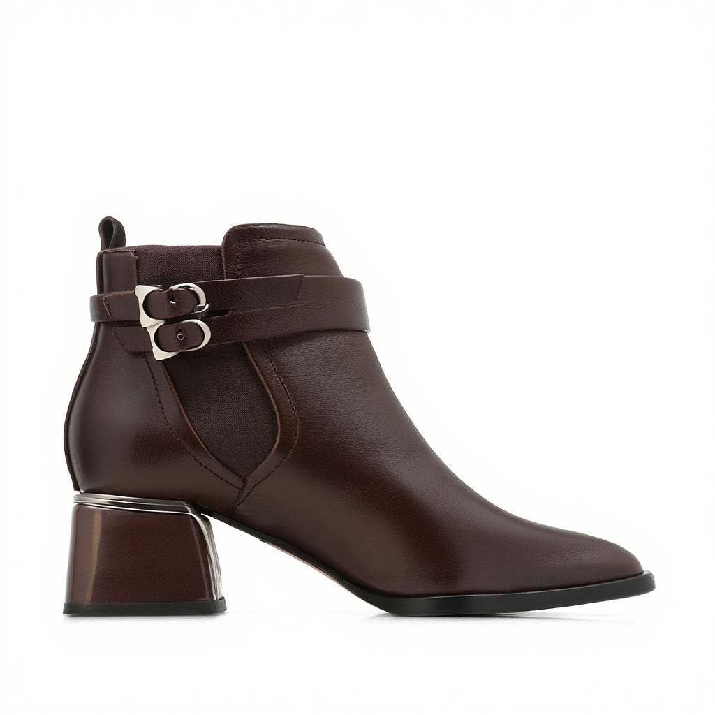 Brown ankle boot with a buckle on a white background