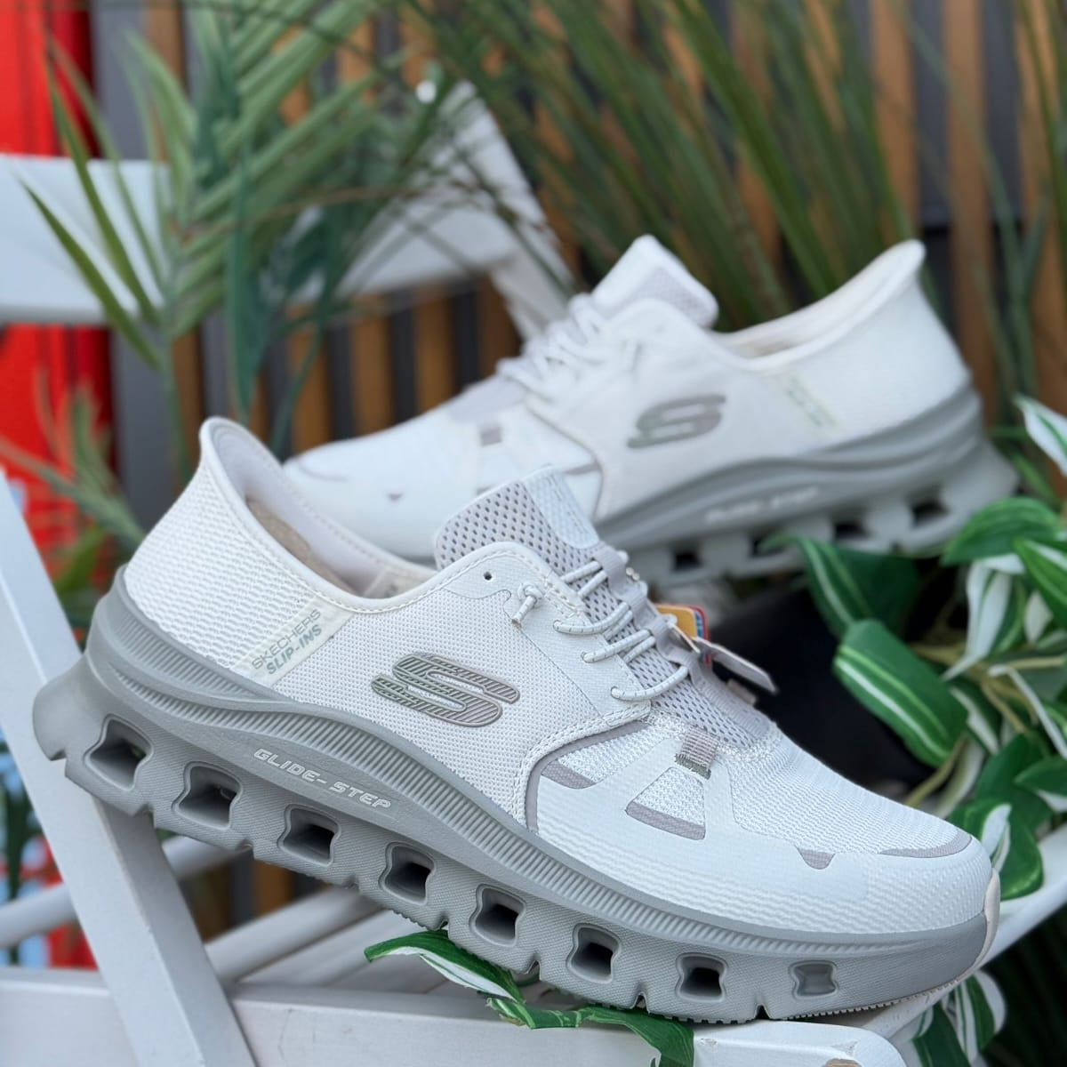 Pair of Skechers Slip-Ins Glide-Step Pro sneakers displayed outdoors with plants in background