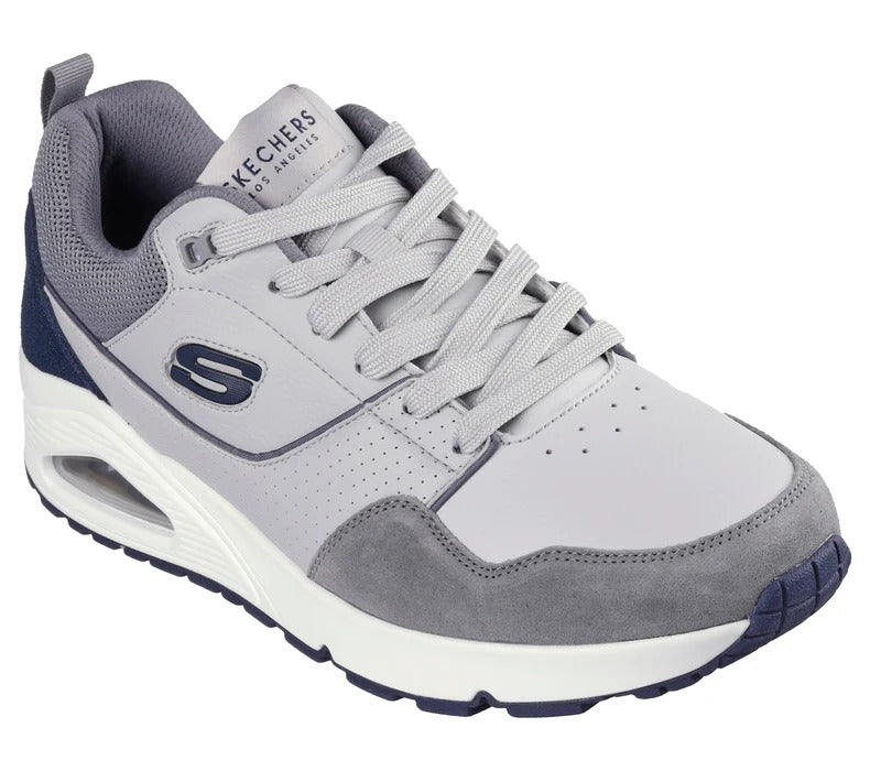 Angled view of Skechers UNO Retro One men’s gray sneakers highlighting suede and leather details.
