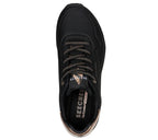 Top view of Skechers Uno Shimmer Away women’s black sneakers showing gold metallic details and Air-Cooled Memory Foam insole.