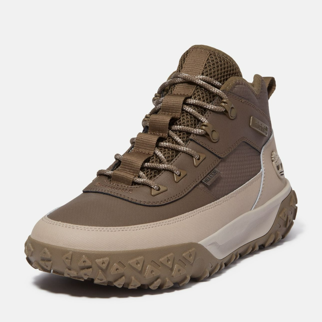 Angled view of Timberland GS Motion waterproof beige boots featuring textured rubber outsole and lace-up front.