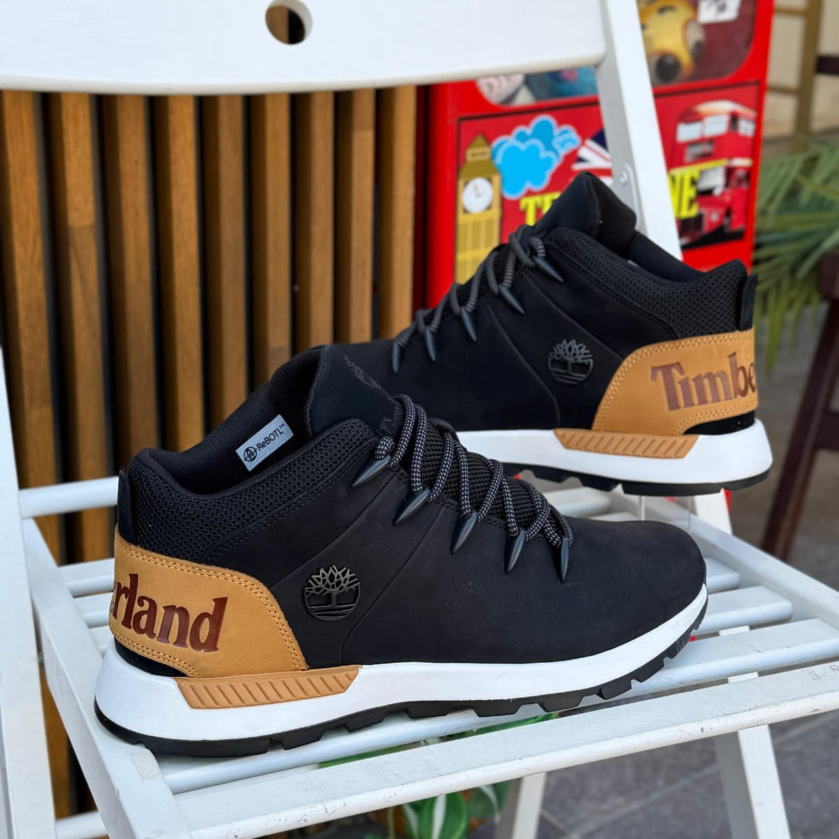 Timberland Sprint Trekker Mid black brown men’s boots outdoor on white chair background