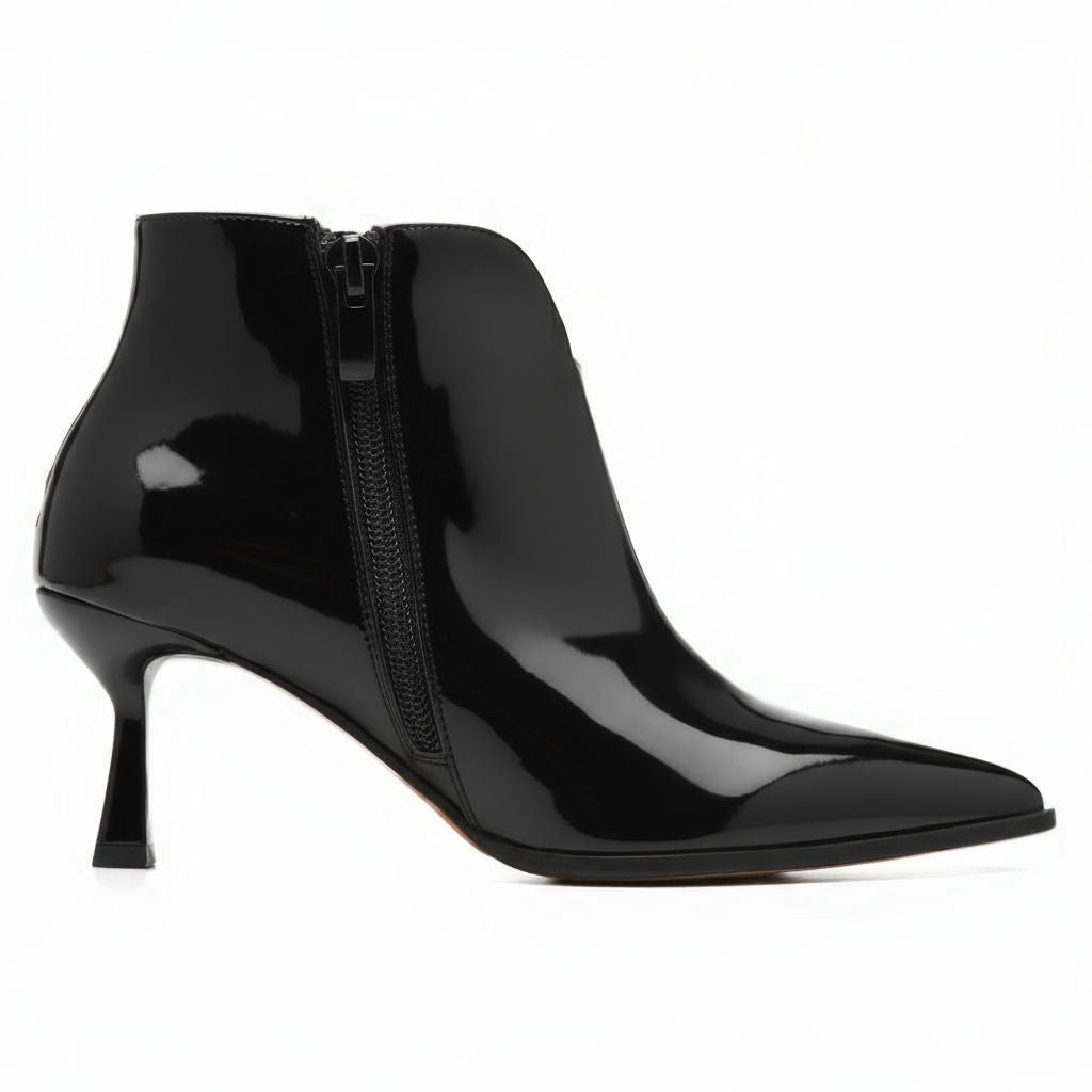 Black patent leather ankle boot with a zipper on a white background