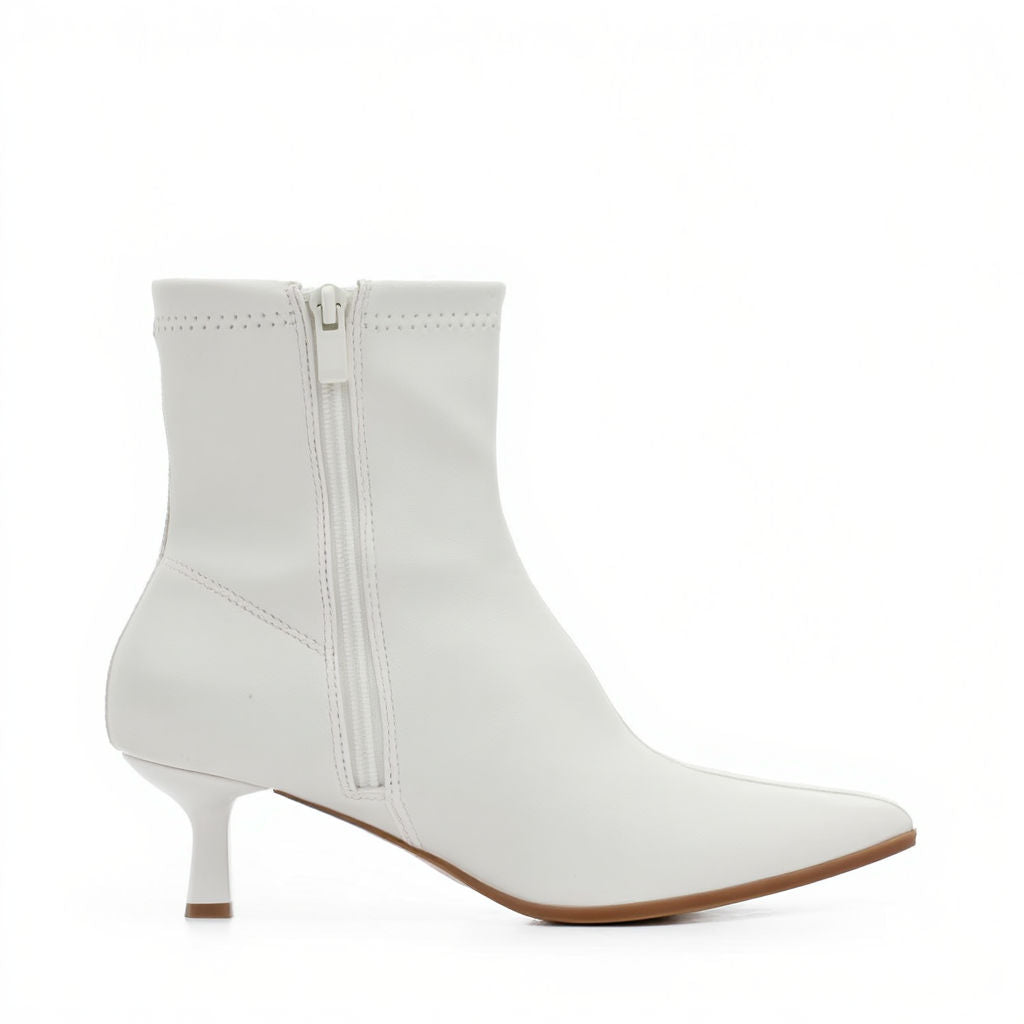 White ankle boot with a zipper on a white background