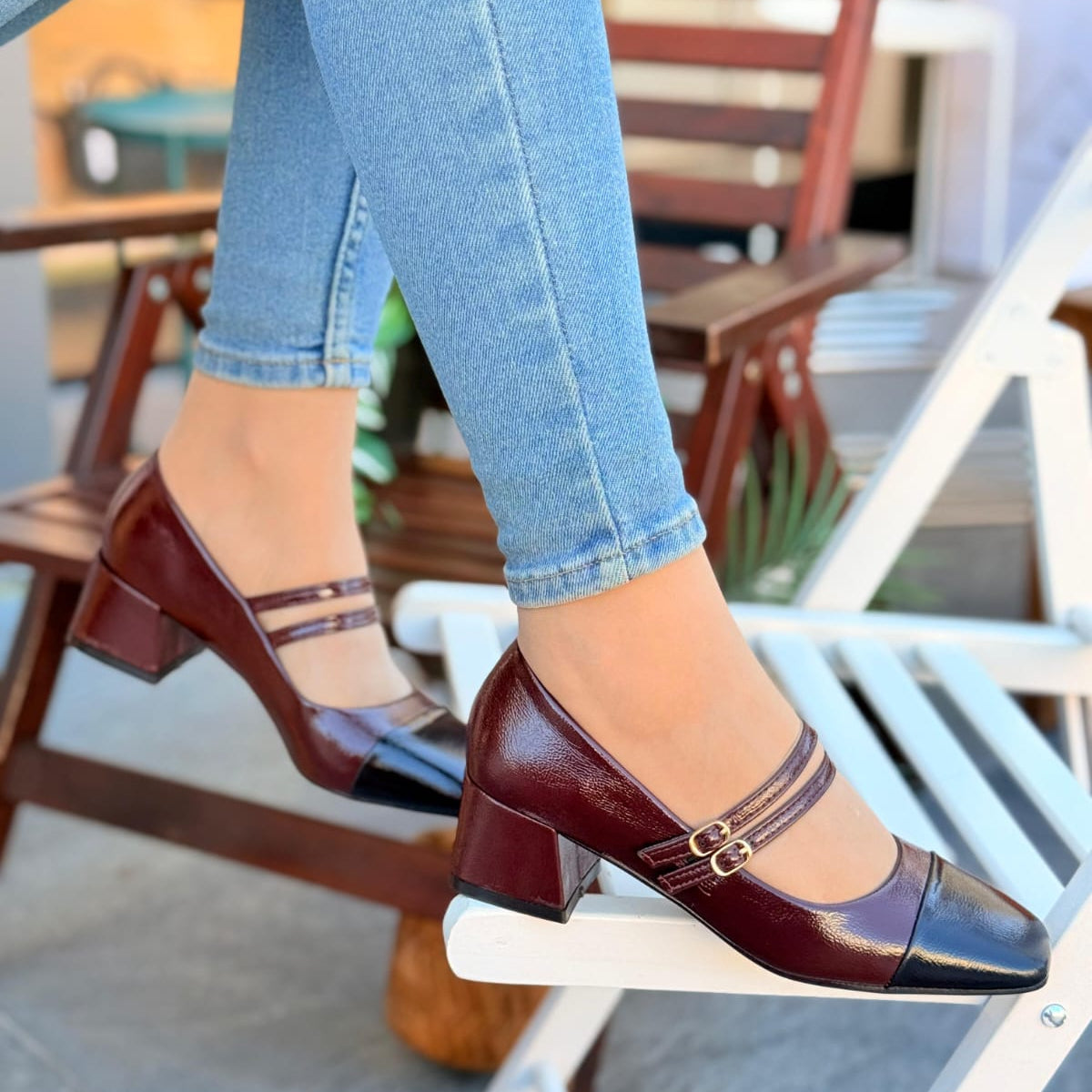 Women's Bordeaux burgundy patent leather Mary Jane heels with black cap toe and gold buckles 
