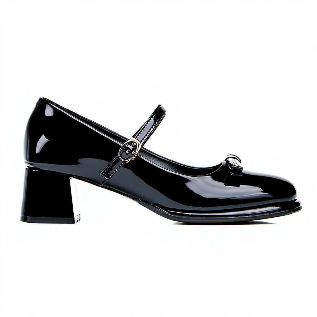 Black patent leather shoe with a strap on a white background