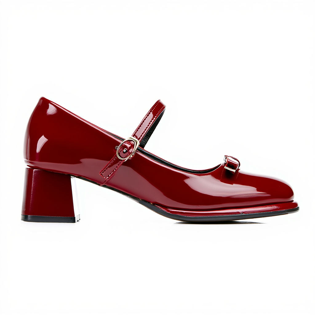 Red patent leather shoe with a strap on a white background