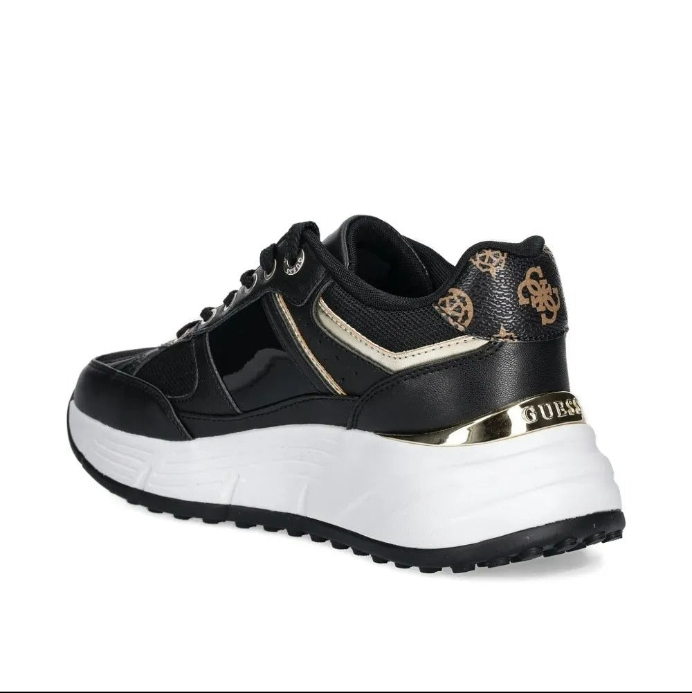 Black and white sneaker with gold accents on a white background