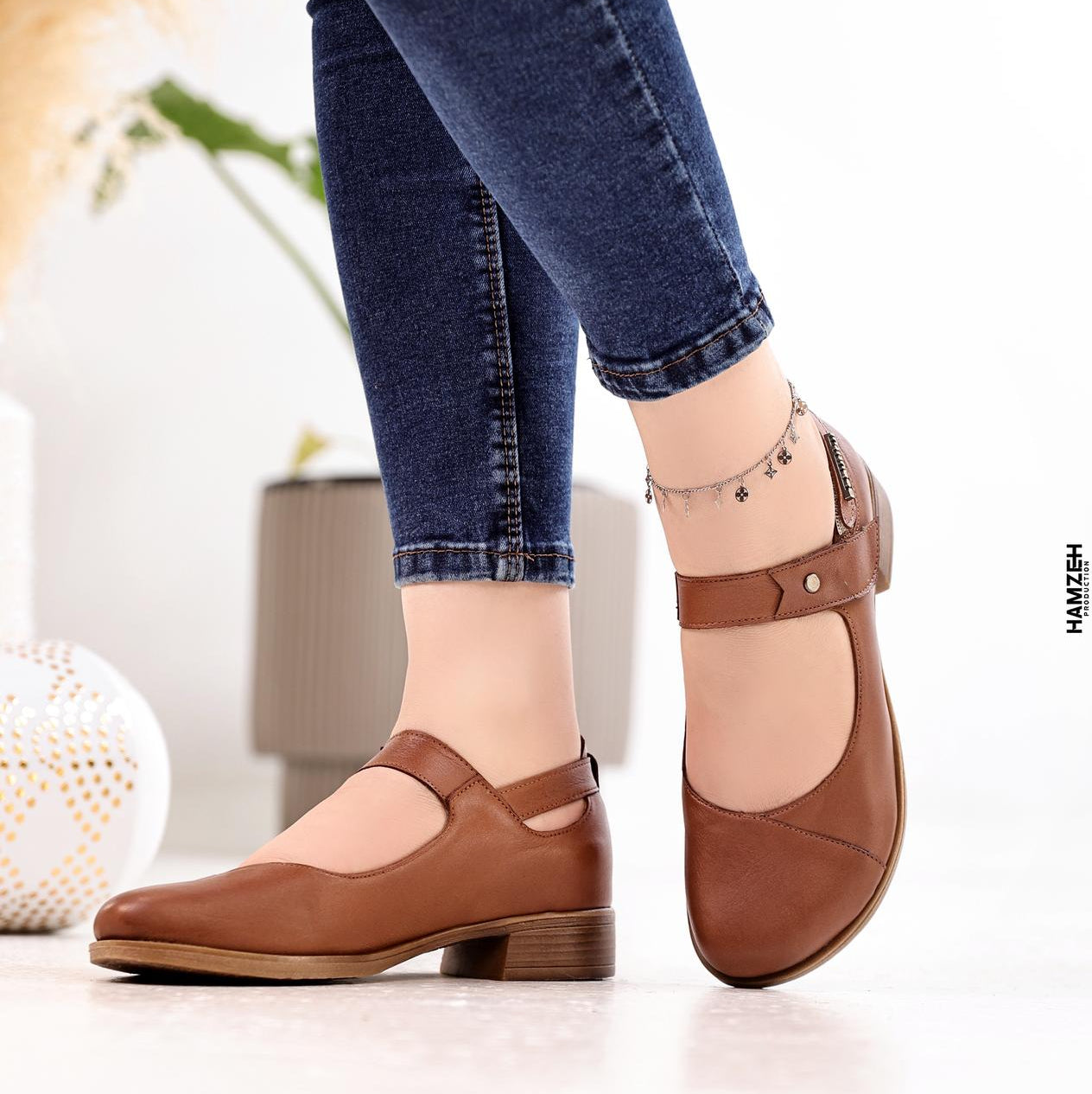 Brown shoes worn with blue jeans on a light background, featuring the 'B Beautiful Comfort' brand.