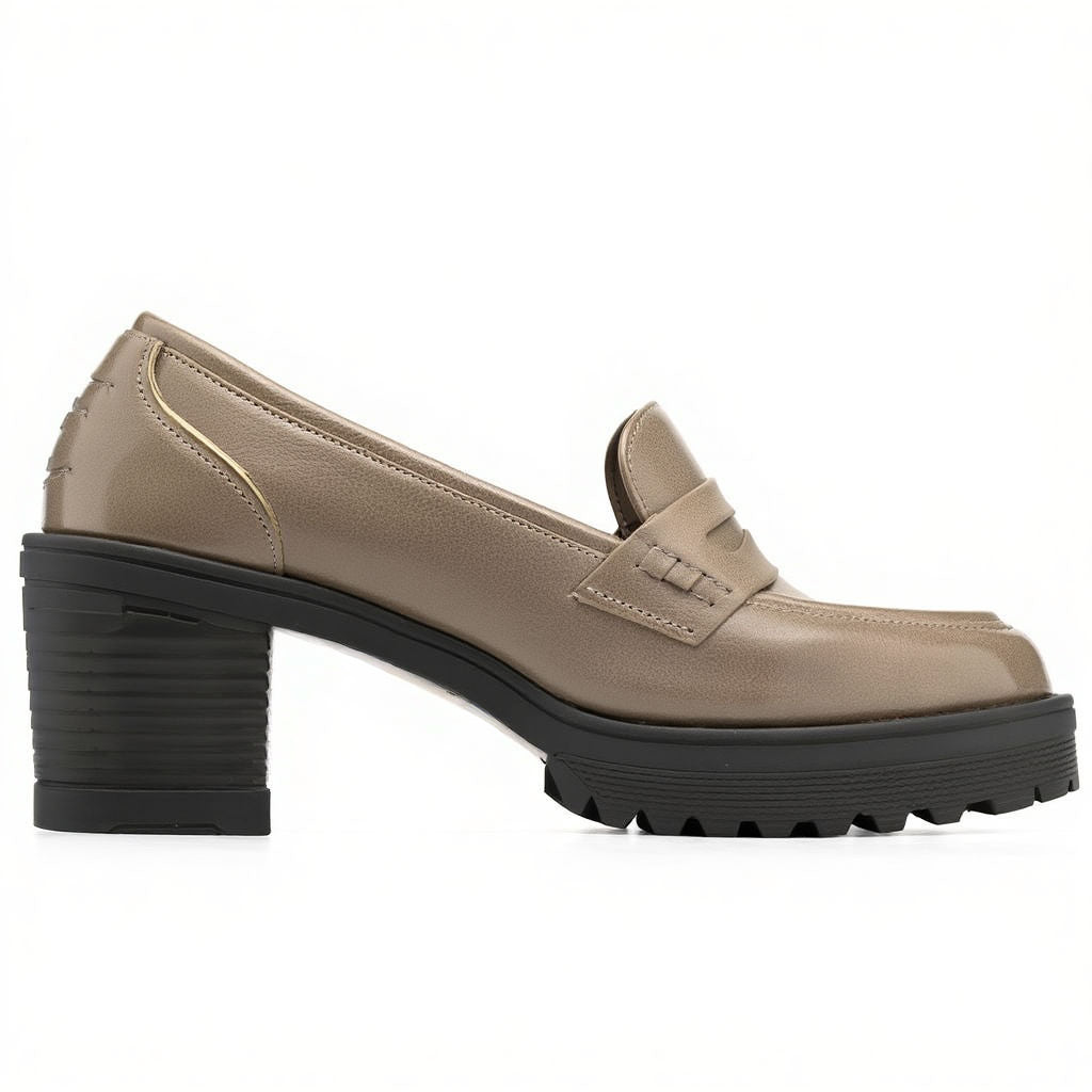 Beige loafer shoe with a black sole on a white background