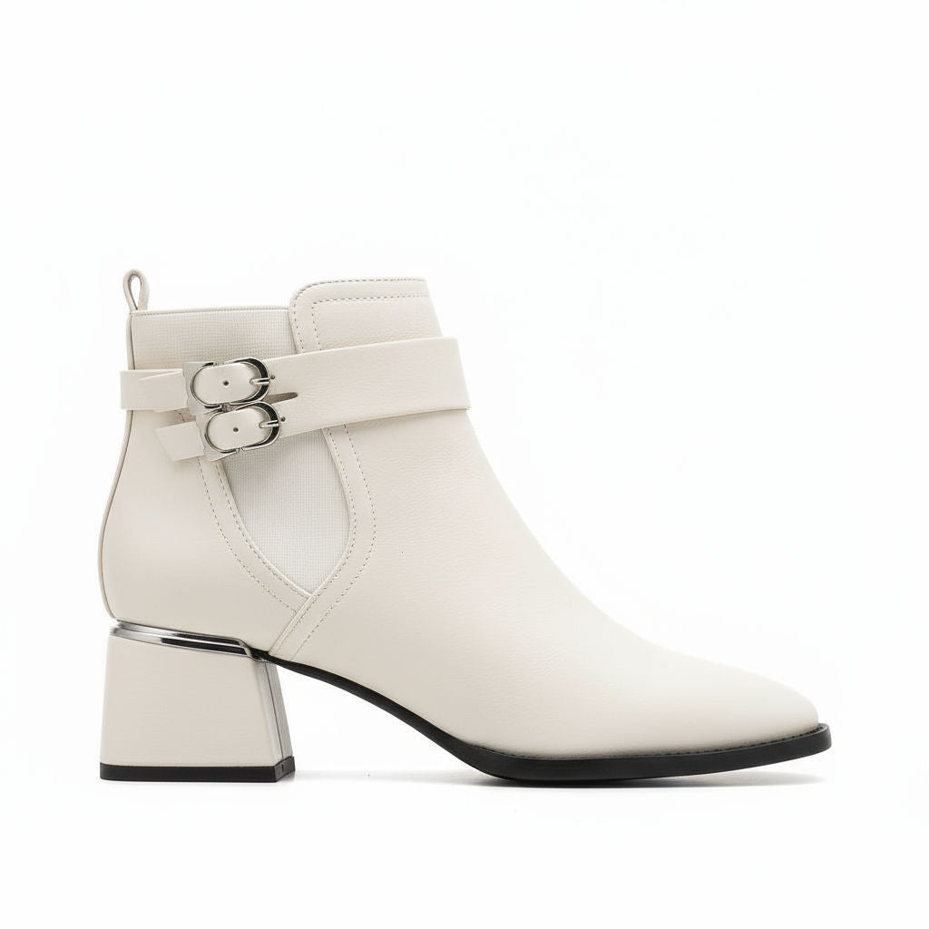White ankle boot with buckles on a white background