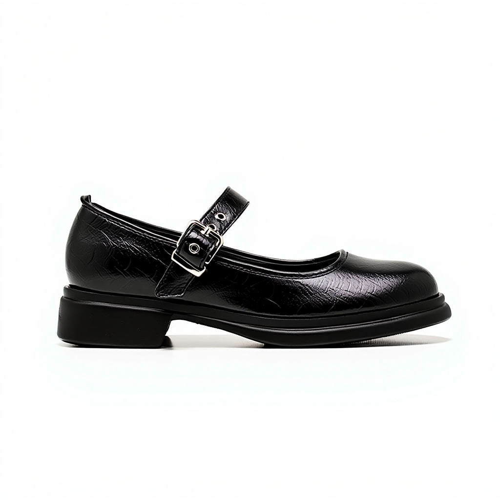 Black leather shoe with a buckle on a white background